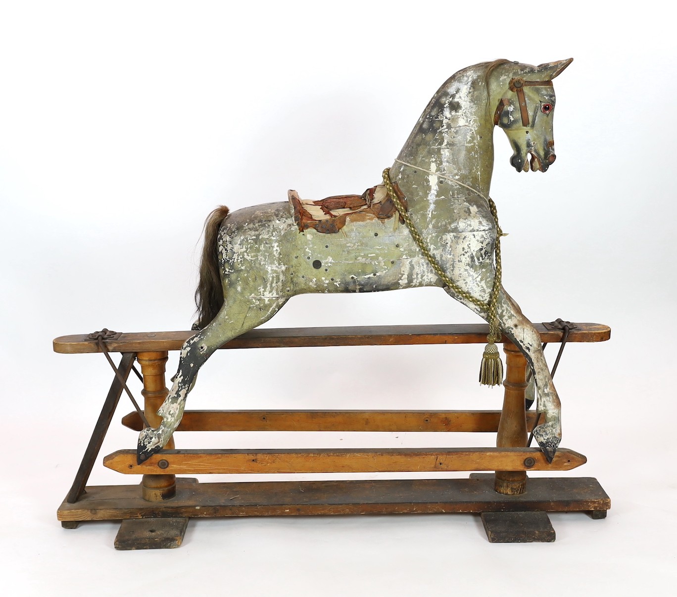 A Victorian carved and painted wood rocking horse, 174cm long 145cm high